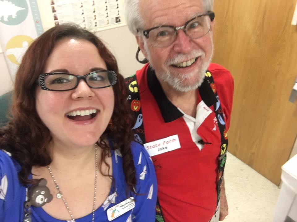 Greg with his adult daughter, Rebeca, smiling at the camera in their hospital office